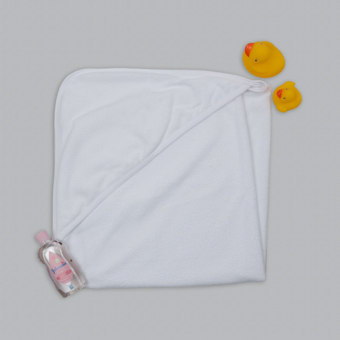 White hooded towel with a bottle and rubber ducks on a gray background