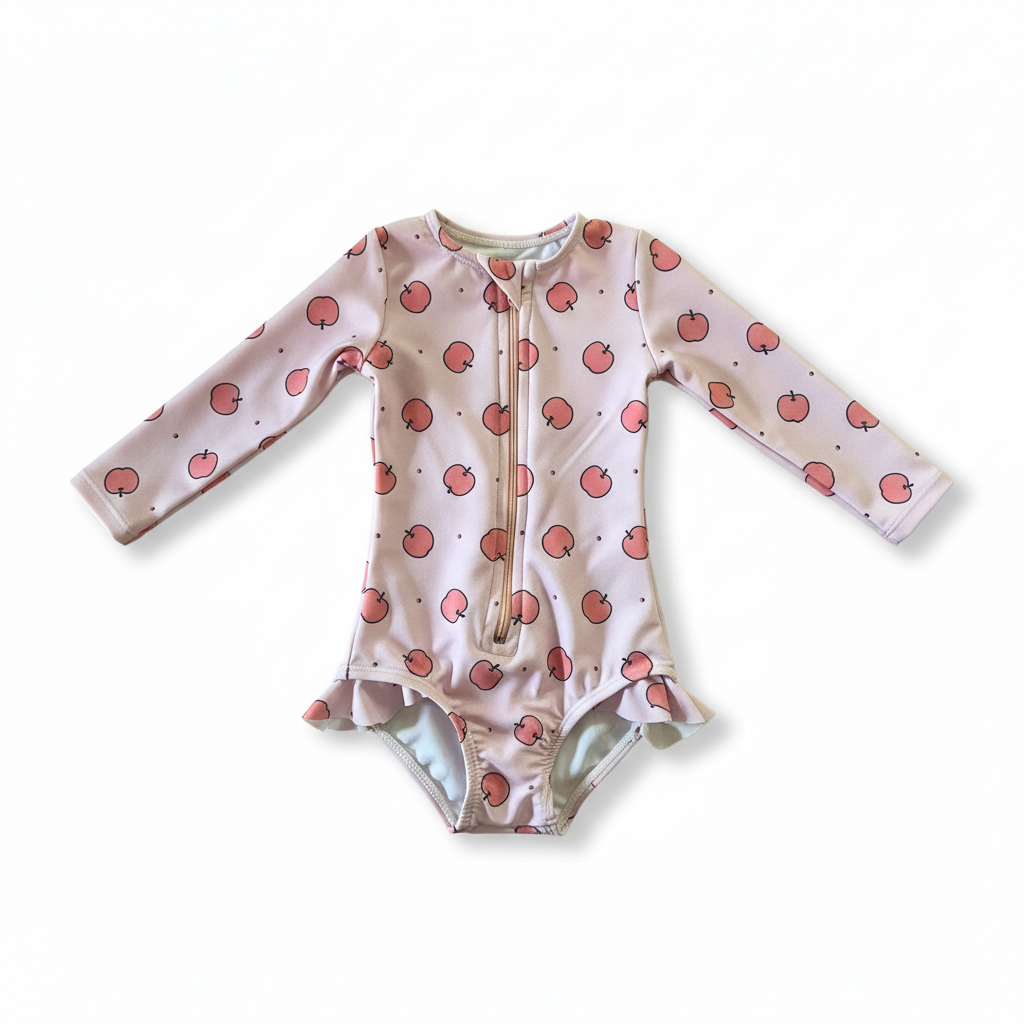 Baby onesie with peach pattern on a light green background