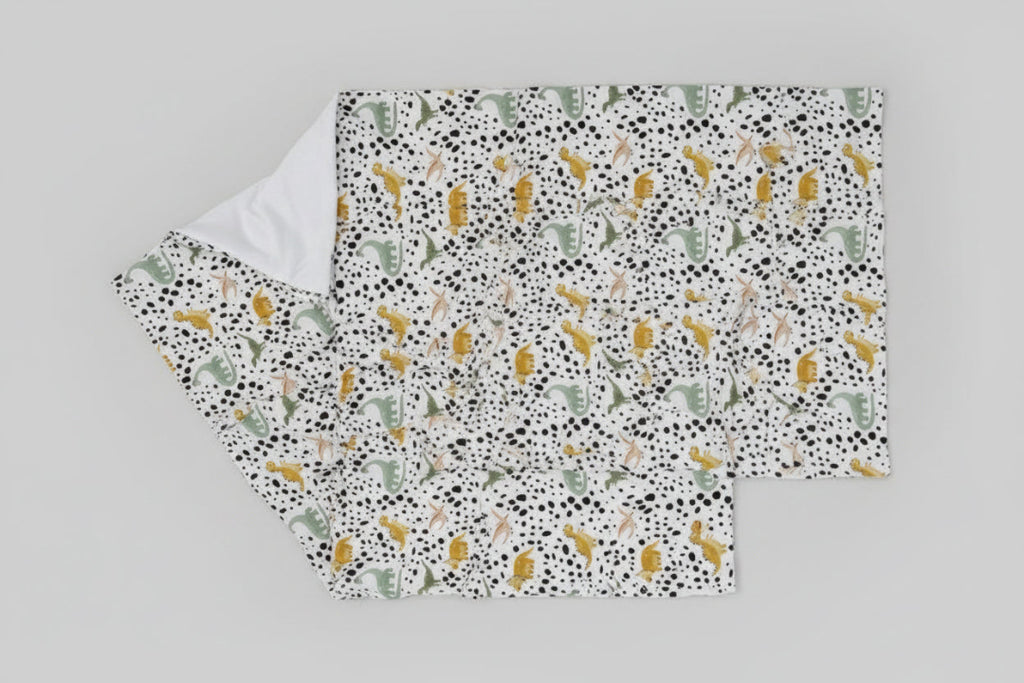 Fabric with dinosaur pattern on a white background