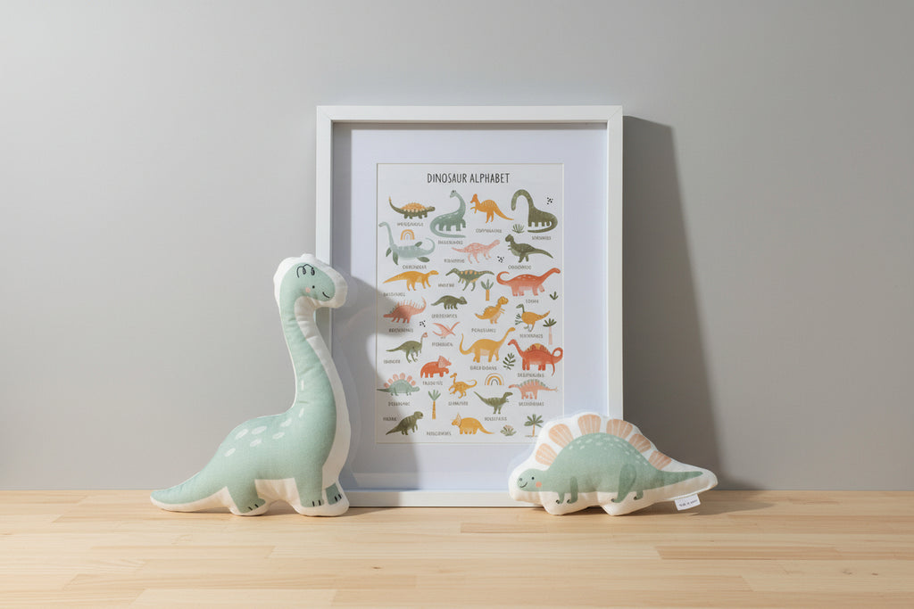 Framed dinosaur illustration with two dinosaur-shaped toys on a wooden board.