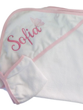 White hooded towel with pink trim and embroidered name 'Sofia' on a white background