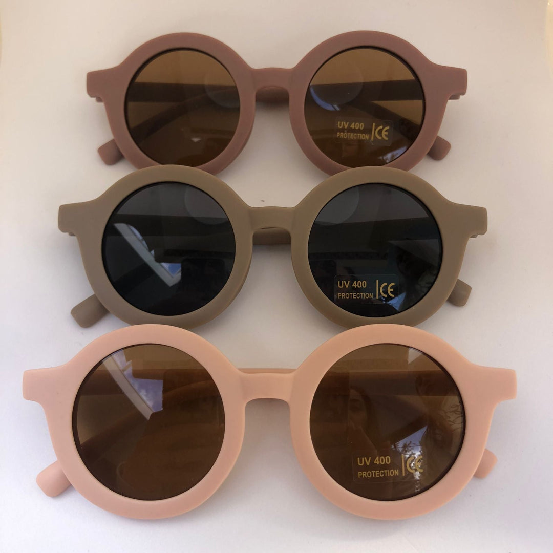 Three pairs of sunglasses with different colored frames on a white background.