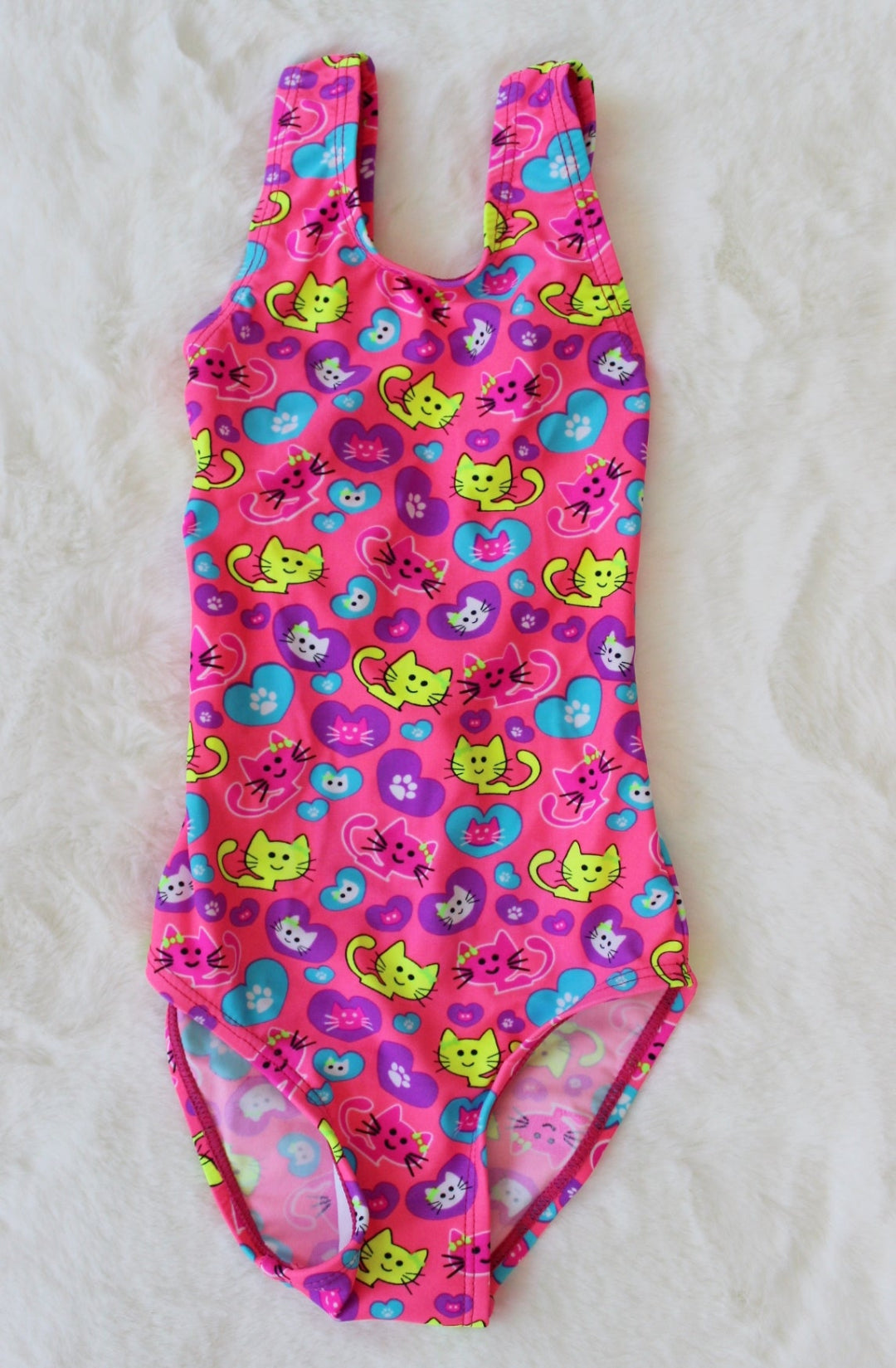 Pink swimsuit with cat pattern on a white background