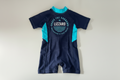 Navy and teal swimsuit with 'Lizzard' branding on a light gray background