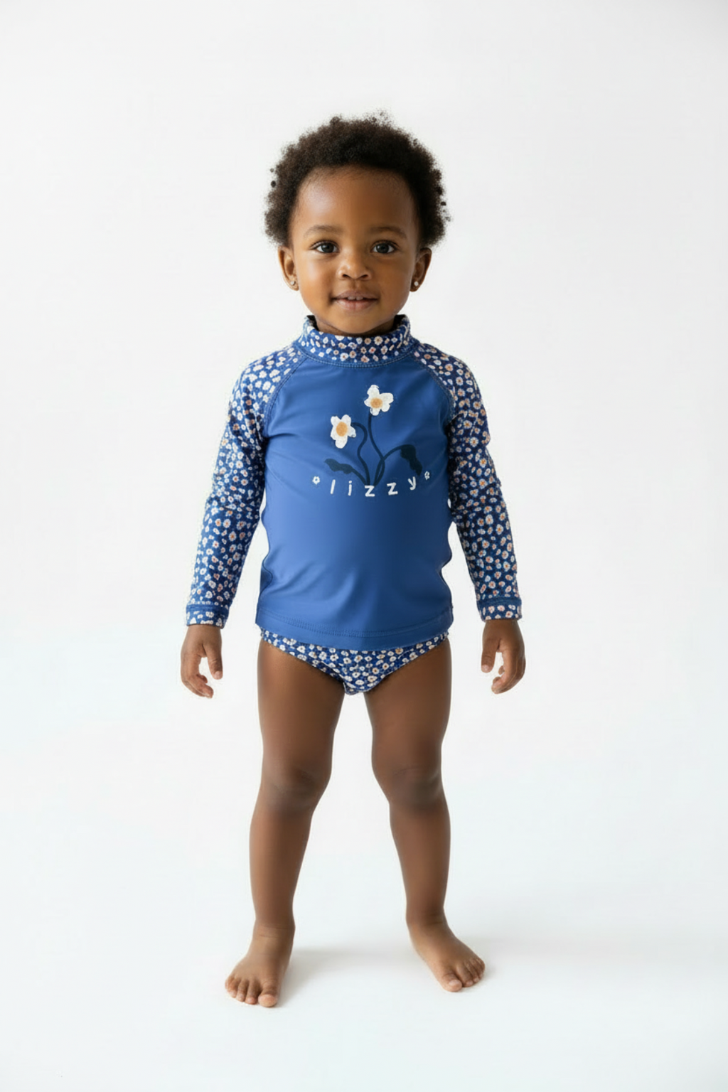 Blue children's swimsuit with floral pattern and 'lizzy' branding on a white background