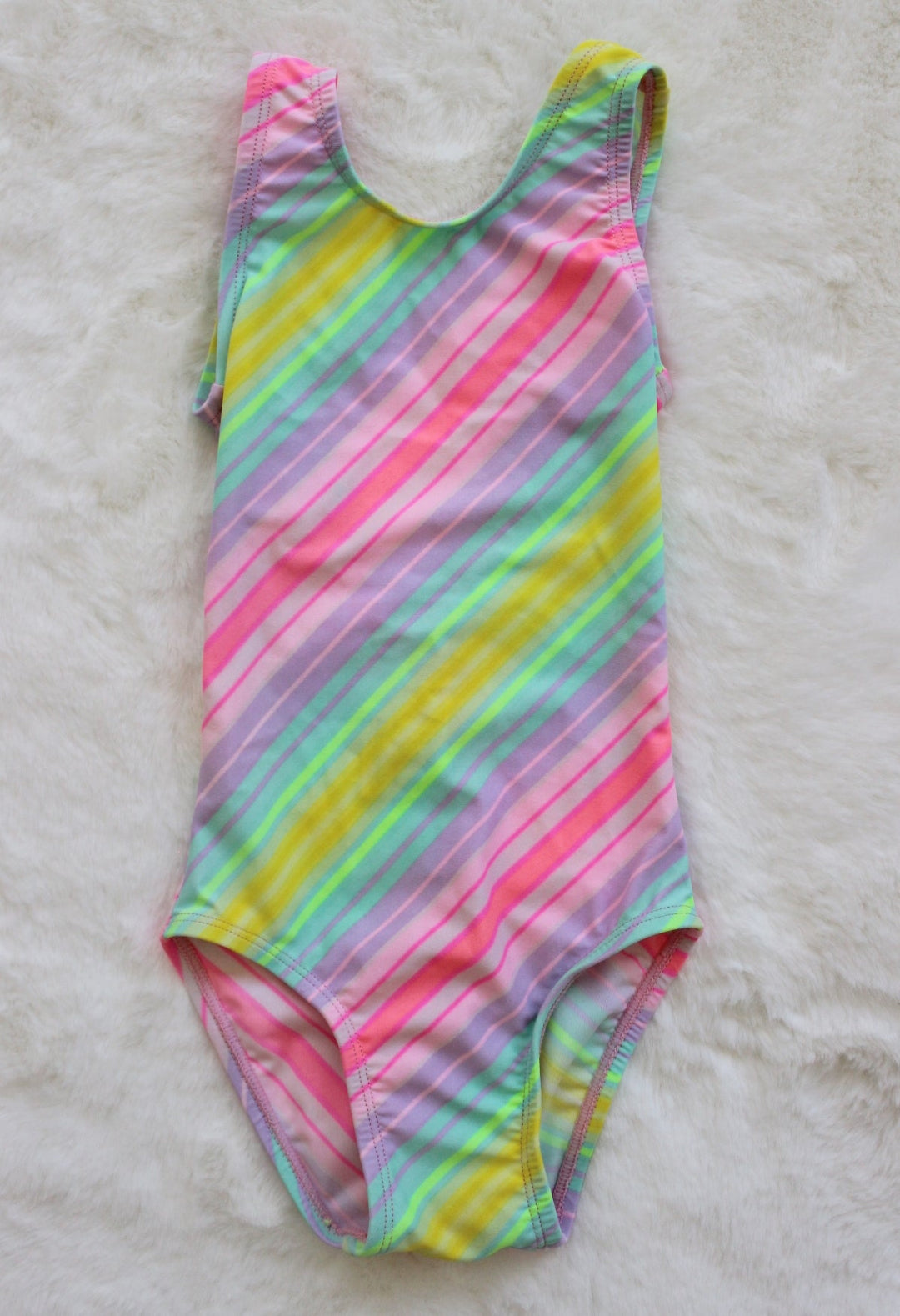 Multicolored striped swimsuit on a light gray background