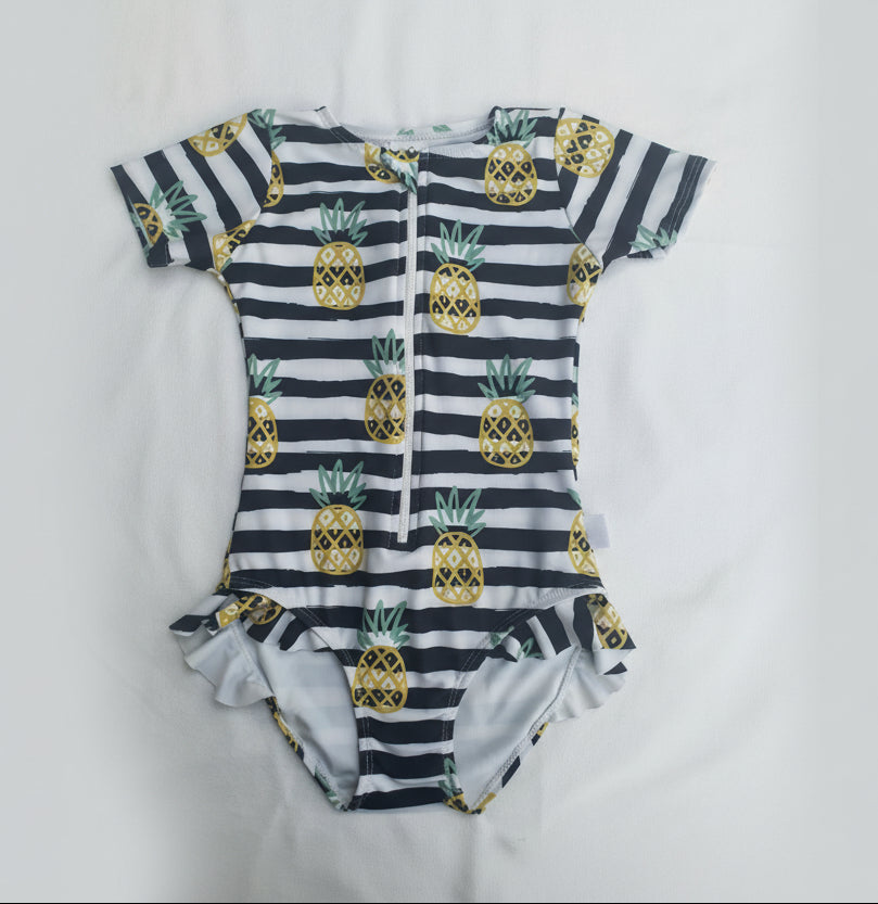 Children's swimsuit with pineapple pattern on a white background