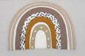 Baby crib with decorative elements and a white wall in the background