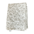 Folded fabric with a subtle pattern on a white background