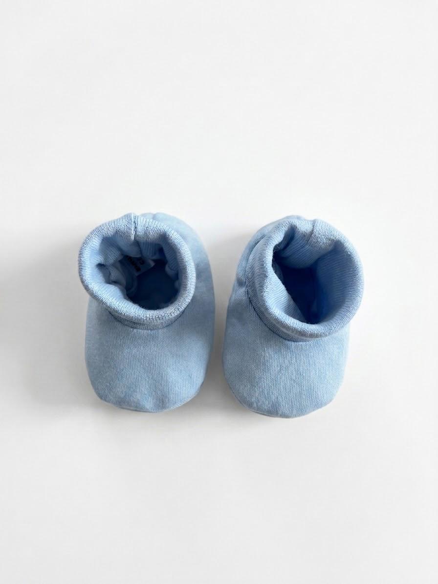 baby blue ribbed shoes or booties on whited background