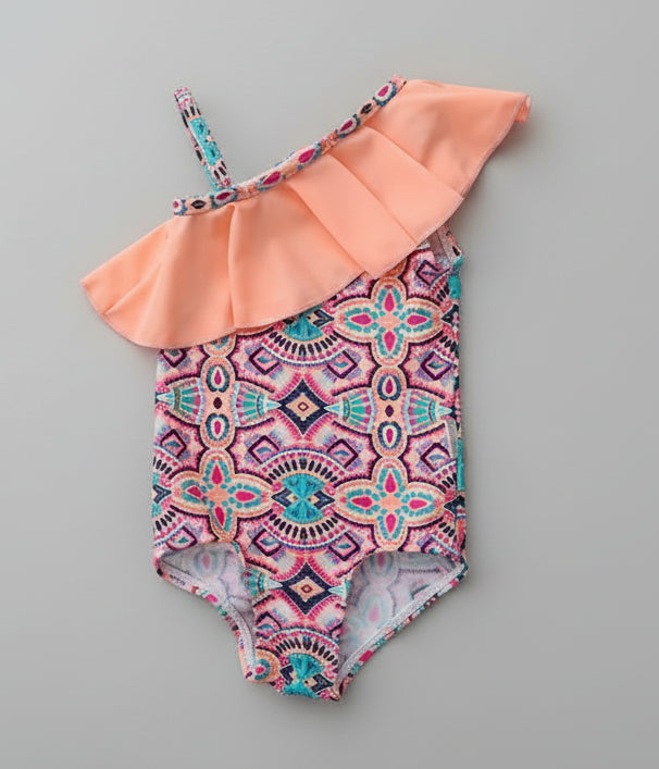Children's swimsuit set with hat and headband on a wooden surface