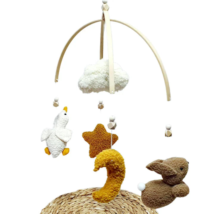 Baby mobile with plush toys including a duck, star, and rabbit on a white background
