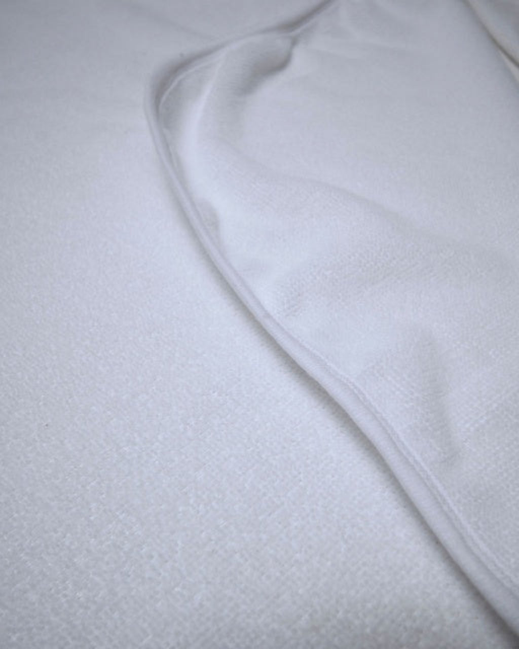 Close-up of white fabric with a textured pattern