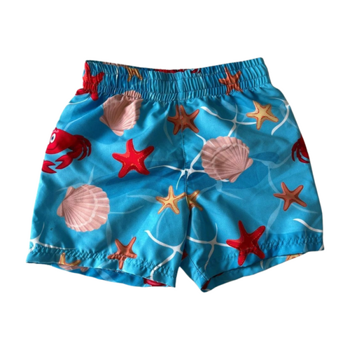 Children's swim shorts with sea-themed pattern on a white background