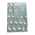 Folded fabric with goose pattern on a light blue background