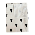 Folded blanket with black triangle patterns on a white background