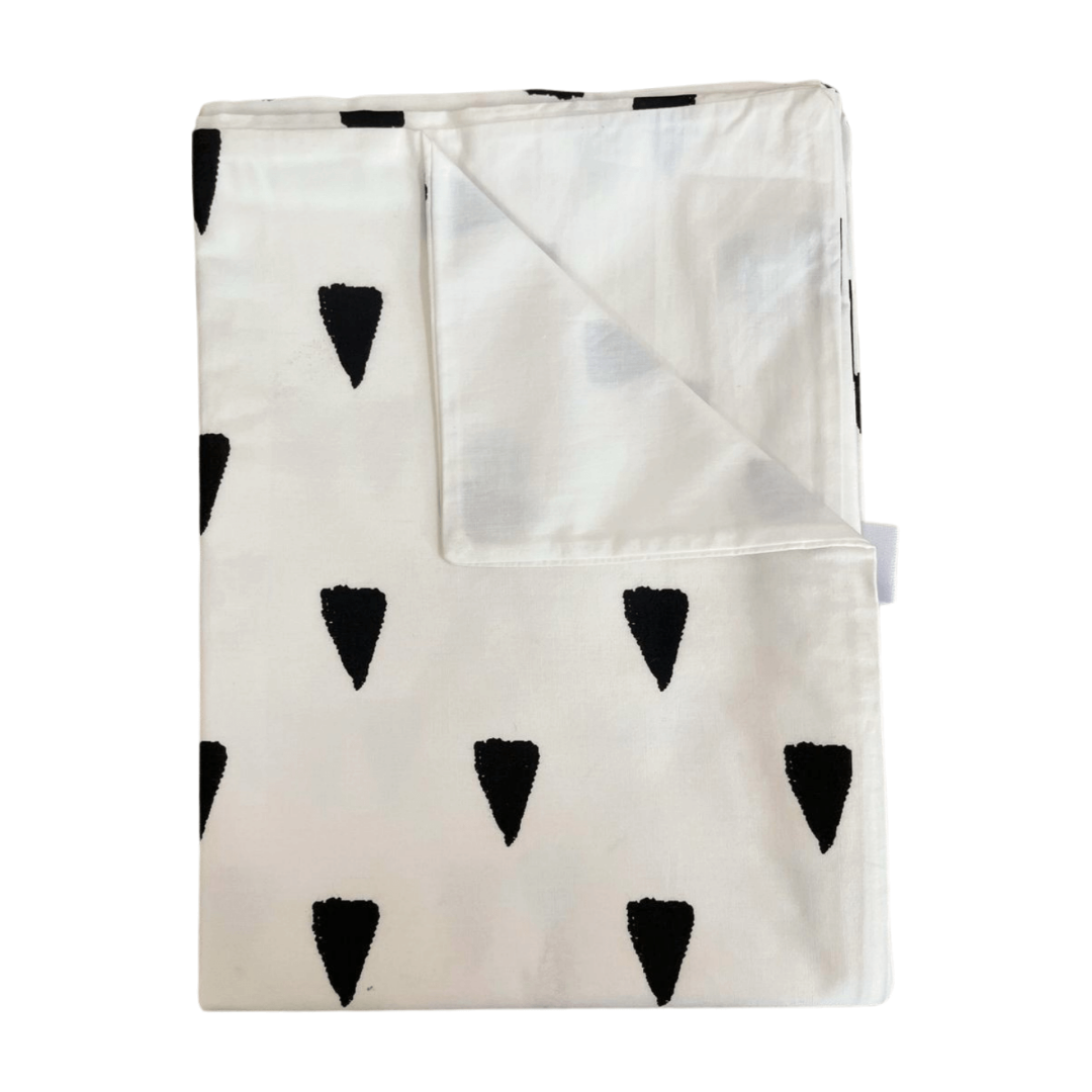 Folded blanket with black triangle patterns on a white background