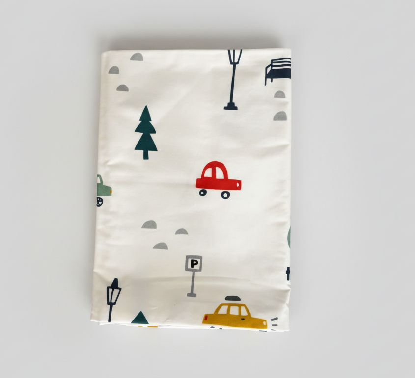 Fabric with car and tree patterns on a white background