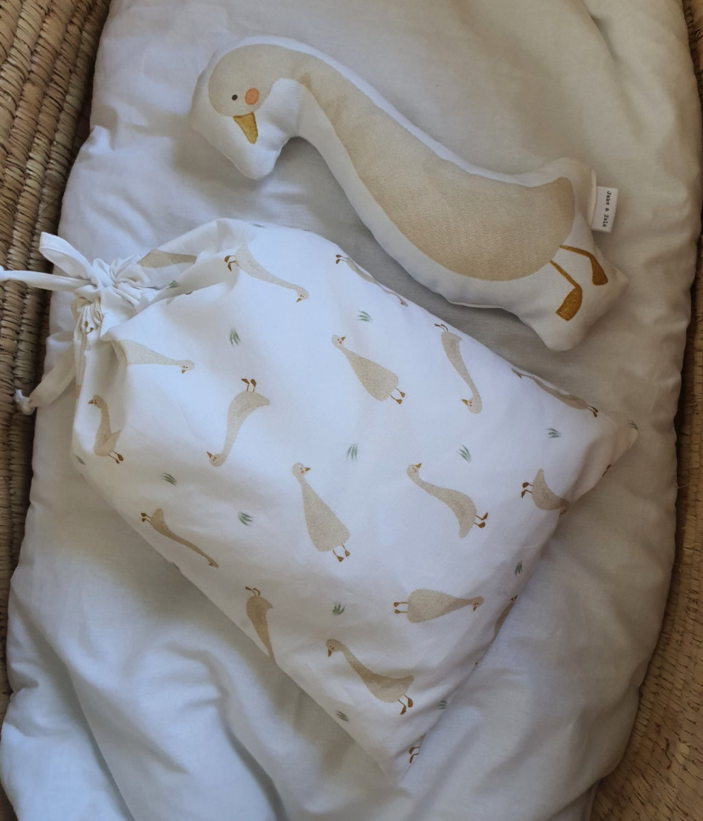 Baby crib set with swan design in a wicker crib