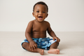 Blue and white floral patterned shorts with built in nappy on a white background