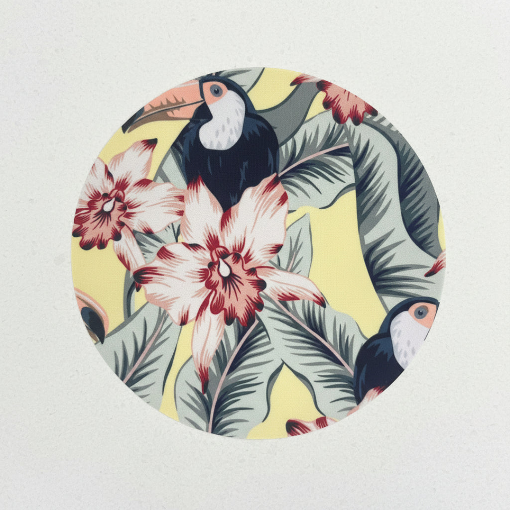 Tropical fabric pattern with toucans, flowers, and leaves on a yellow background