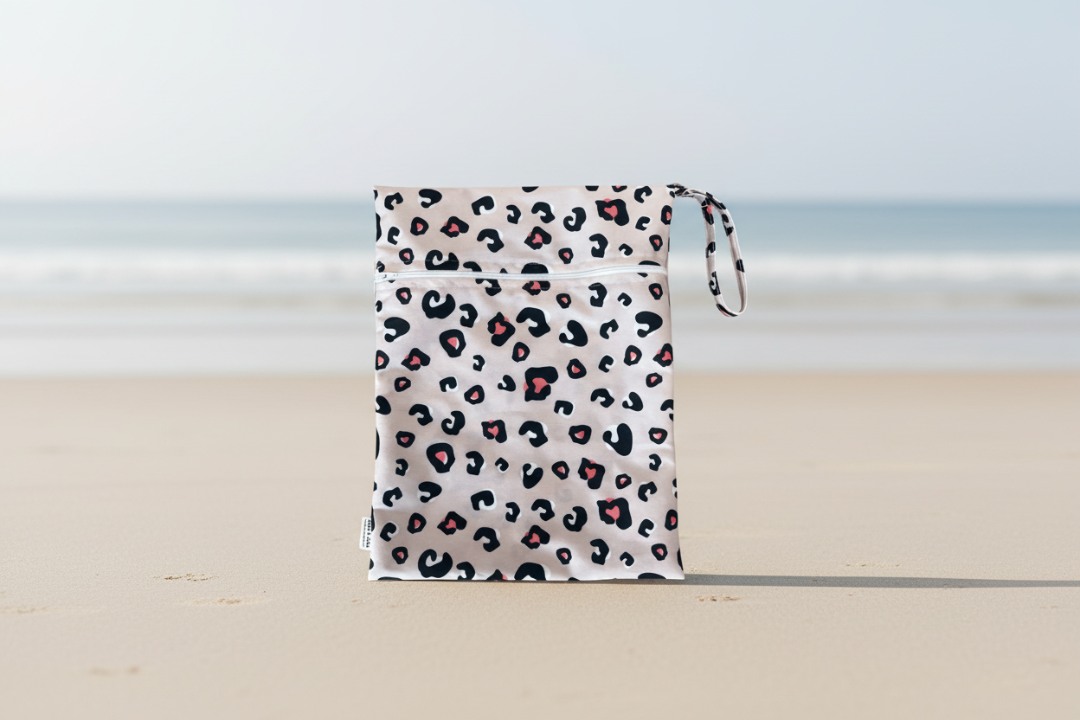 Leopard print bag with pink accents on a white background