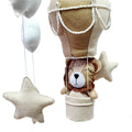 Children's mobile with lion toy and star-shaped elements on a white background