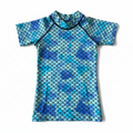 Blue and green mermaid scale patterned shirt on a white background