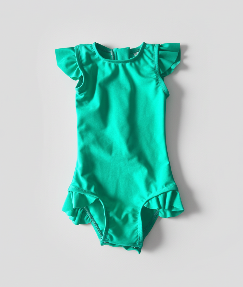 Green swimsuit with ruffled sleeves and bottom on a white background