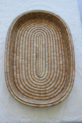 Wooden woven moses basket on a white background