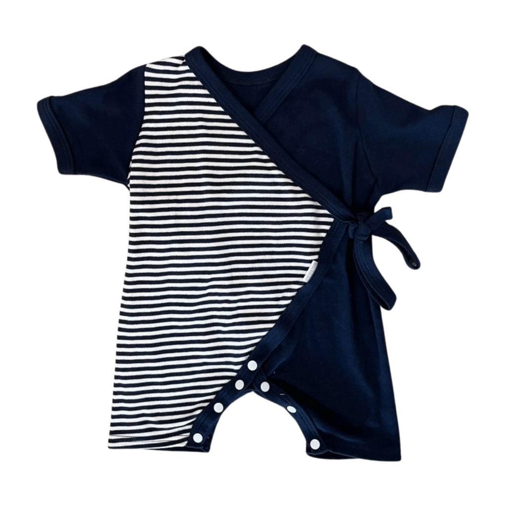 Navy and white striped baby romper with a tie front on a white background