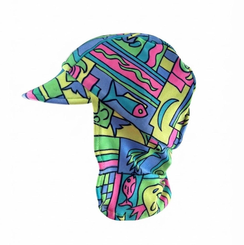 A swim hat with a matching neck gaiter in a vibrant, multicolor abstract pattern featuring pink, green, blue, and yellow shapes, shown on a plain white background.