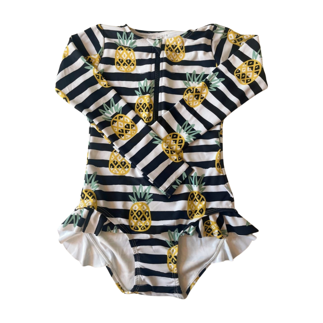 Striped baby swimsuit with pineapple pattern on a white background