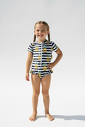 Striped swimwear costume with pineapple pattern on a white background