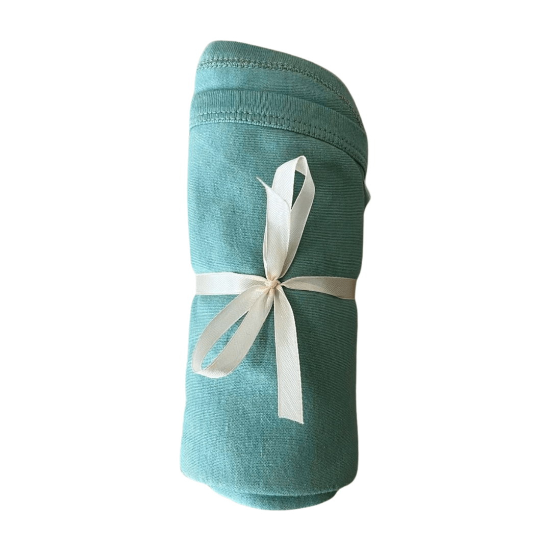 Teal fabric roll with a white ribbon on a white background