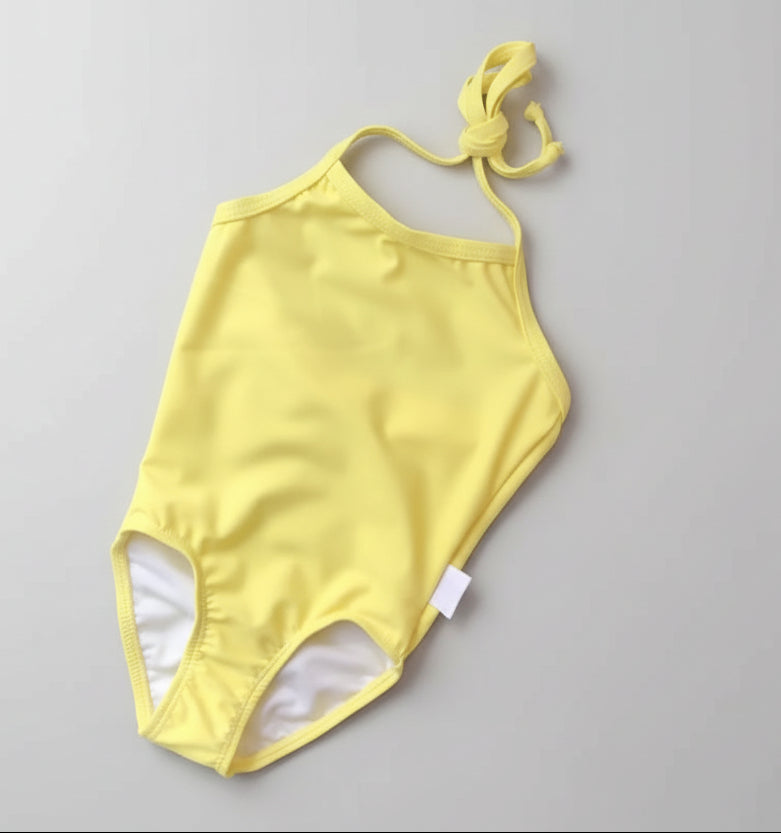 Yellow swimsuit on a green textured surface