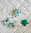Baby mobile with dinosaur, cloud, and star toys on a textured white background