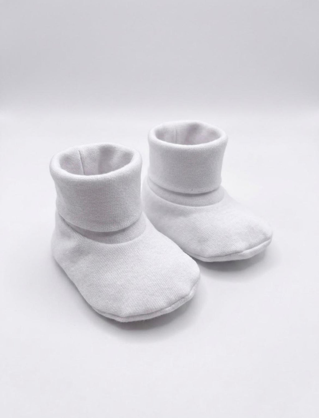 white booties or ribbed shoes on white background 
