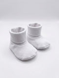 white booties or ribbed shoes on white background 

