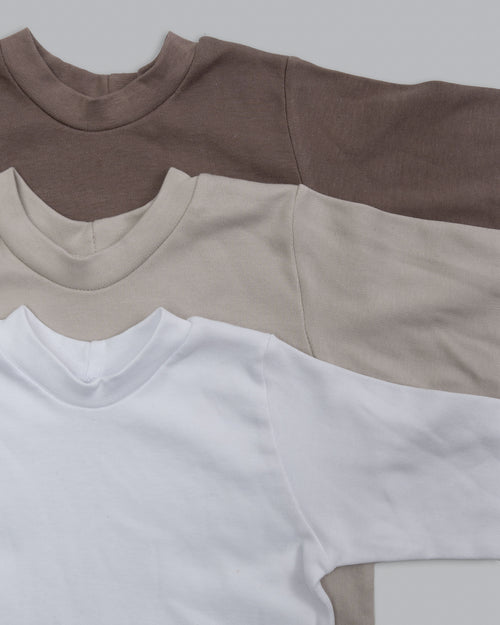 three different colours oversized onesie stacked on top of each other