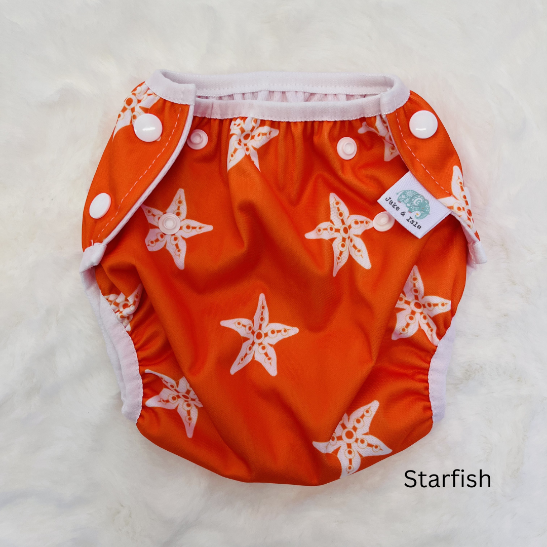 orange and white starfish swim nappy on white background